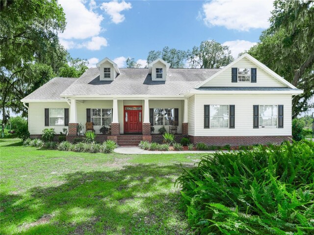 view of front of house featuring a porch and a front lawn