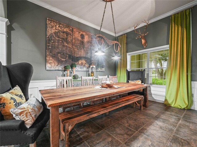 tiled dining room featuring crown molding