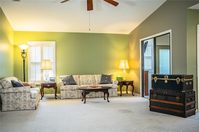 living room with vaulted ceiling, ceiling fan, and carpet floors