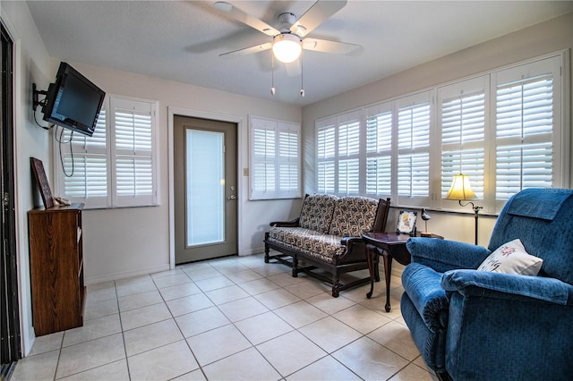 sitting room with light tile patterned floors and ceiling fan