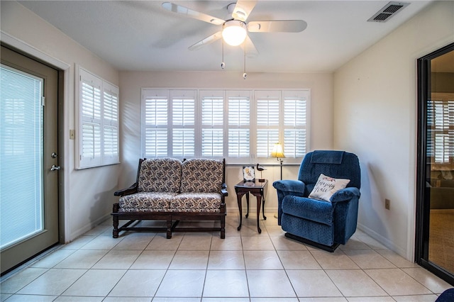 sitting room with ceiling fan and light tile patterned floors