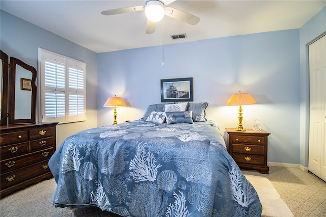 bedroom with ceiling fan and light colored carpet