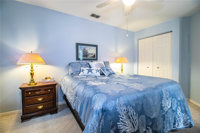 carpeted bedroom with ceiling fan and a closet