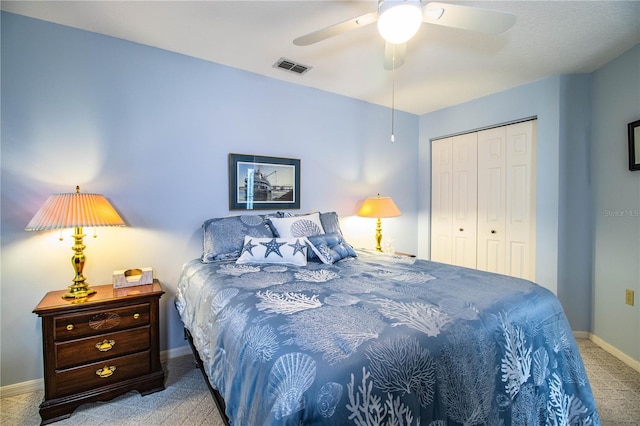 bedroom with ceiling fan, carpet flooring, and a closet