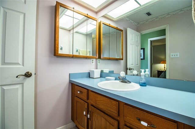 bathroom featuring a skylight and vanity