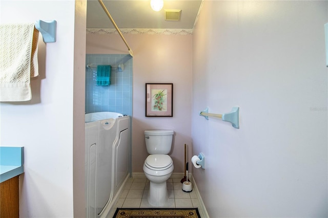 bathroom with toilet, tile patterned floors, and vanity