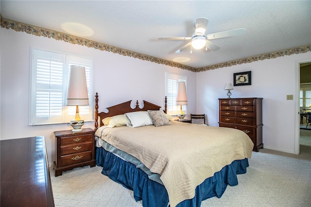 bedroom with ceiling fan and light colored carpet