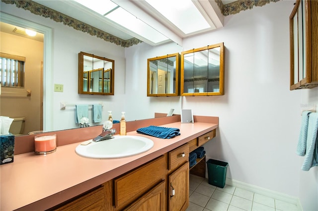 bathroom with tile patterned floors, vanity, and toilet