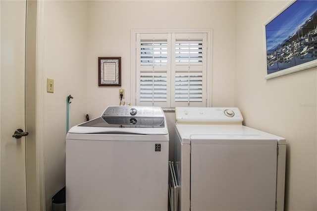 clothes washing area with washing machine and clothes dryer