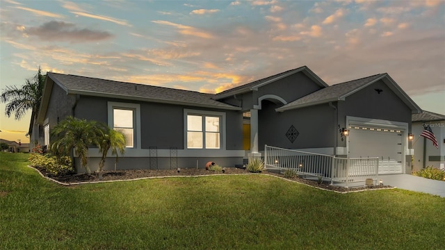 view of front facade with a garage and a lawn