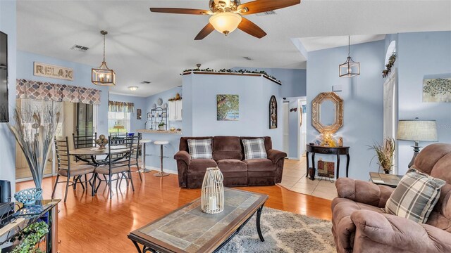 living room with ceiling fan and light hardwood / wood-style flooring