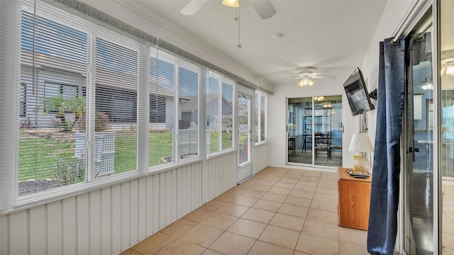 unfurnished sunroom with ceiling fan