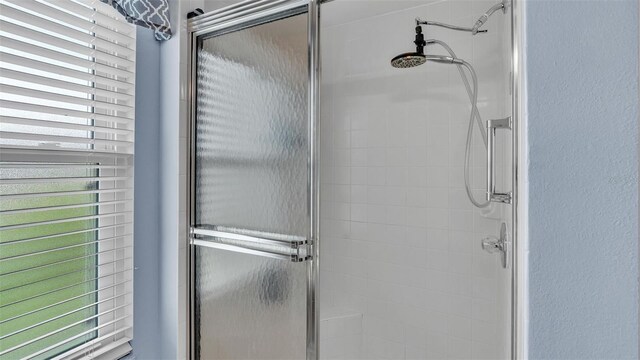 bathroom with a shower with shower door