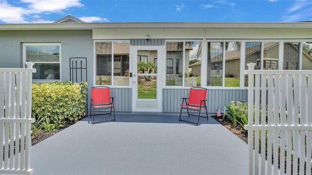 property entrance featuring a patio area