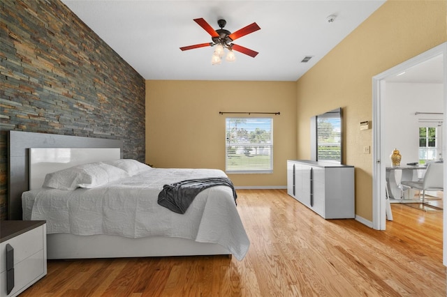 bedroom with ceiling fan and light hardwood / wood-style floors