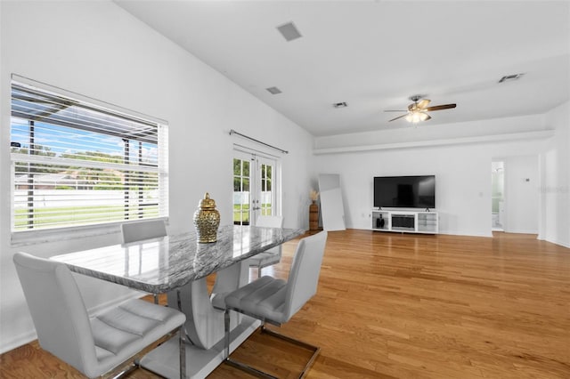 dining room with ceiling fan, light wood-type flooring, and french doors
