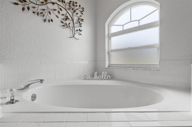 bathroom with tiled bath