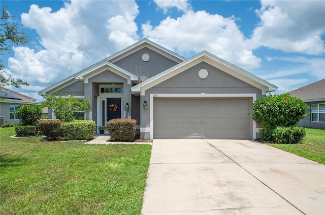 view of front of home featuring a garage and a front lawn