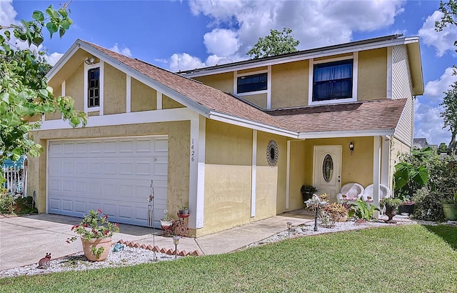 front facade featuring a garage and a front lawn