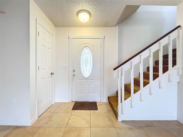 foyer entrance featuring light tile patterned floors