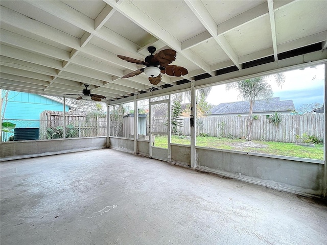 unfurnished sunroom featuring ceiling fan