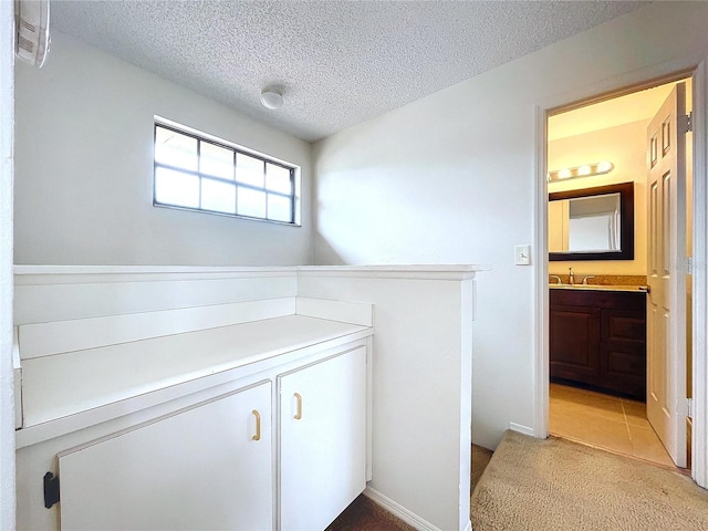 bathroom with vanity and a textured ceiling