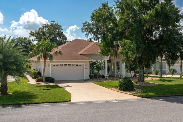 view of front of property featuring a garage and a front yard