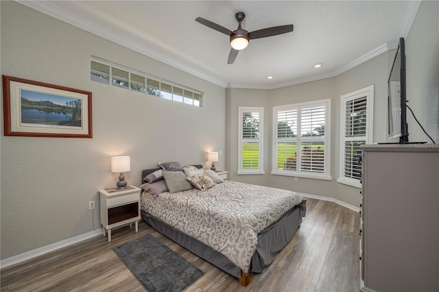 bedroom featuring ornamental molding, hardwood / wood-style floors, and ceiling fan