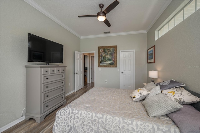 bedroom with hardwood / wood-style floors, crown molding, a textured ceiling, and ceiling fan