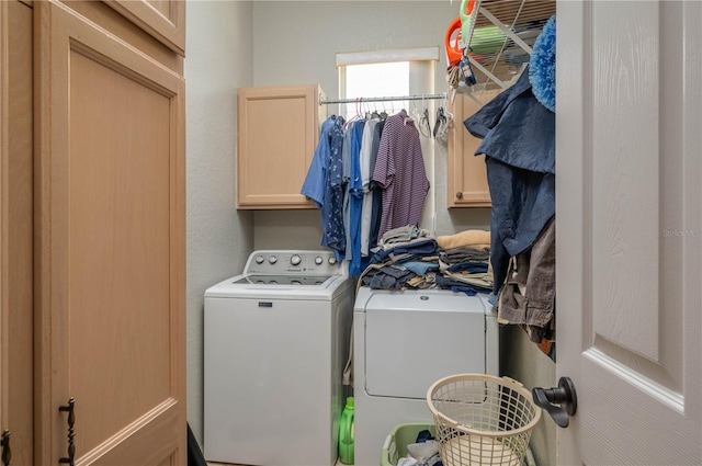 laundry area with cabinets and washing machine and dryer