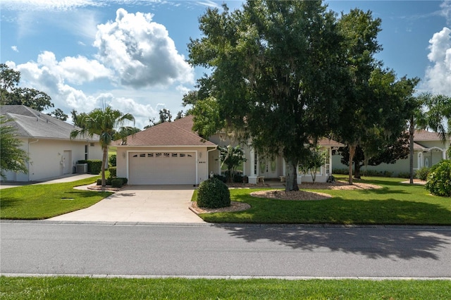 view of front facade with a garage, a front yard, and cooling unit