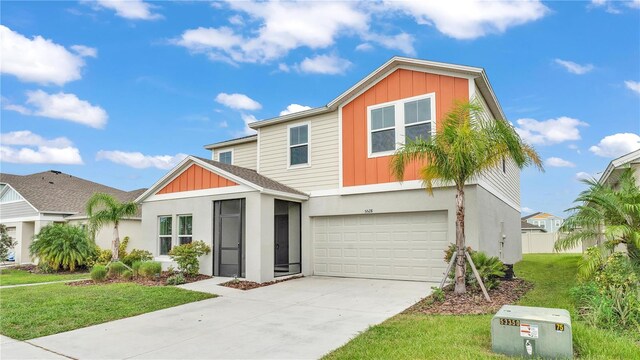 view of front of house with a front yard and a garage