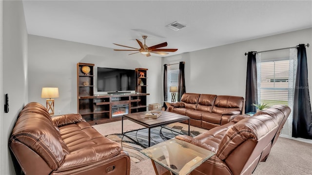 carpeted living room with ceiling fan