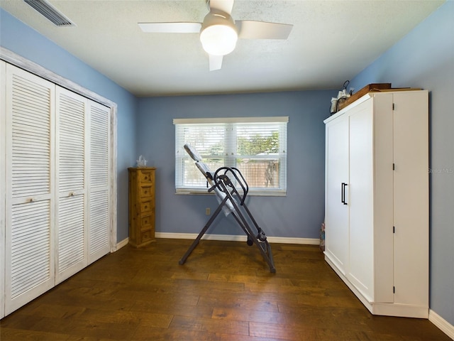 unfurnished bedroom with ceiling fan, wood-type flooring, and a closet