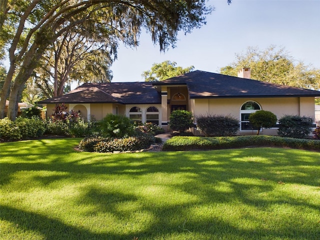 rear view of property featuring a yard