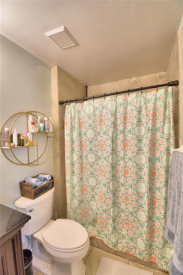 bathroom with vanity, toilet, and walk in shower