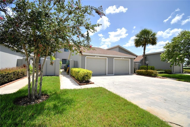 view of front of home with a garage and a front lawn