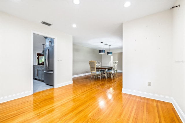 unfurnished room with hardwood / wood-style flooring