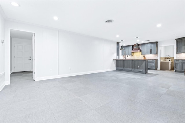 unfurnished living room featuring sink