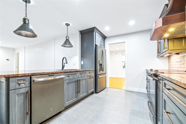 kitchen featuring sink, gray cabinetry, hanging light fixtures, stainless steel appliances, and exhaust hood