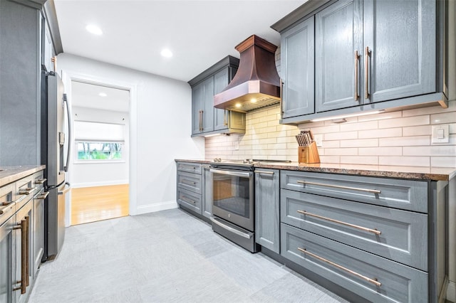 kitchen with ventilation hood, tasteful backsplash, gray cabinets, and stainless steel appliances