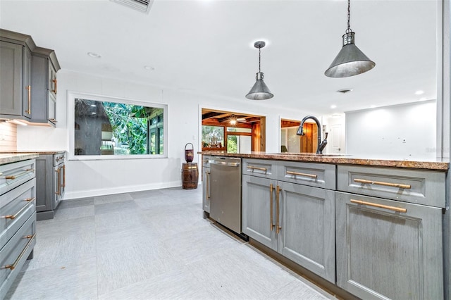 kitchen with pendant lighting, stainless steel dishwasher, sink, and gray cabinetry