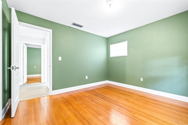 spare room featuring hardwood / wood-style floors