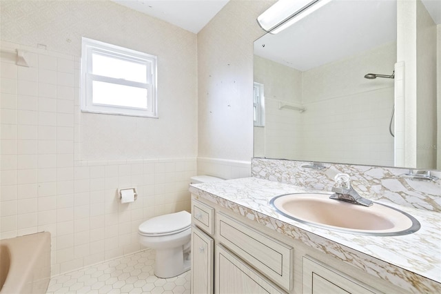 full bathroom featuring shower with separate bathtub, tile walls, vanity, toilet, and tile patterned floors