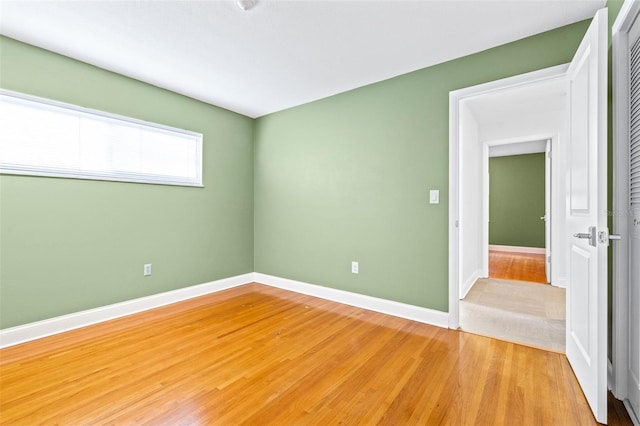 empty room with light hardwood / wood-style floors