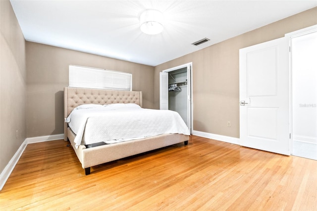 bedroom with wood-type flooring and a closet