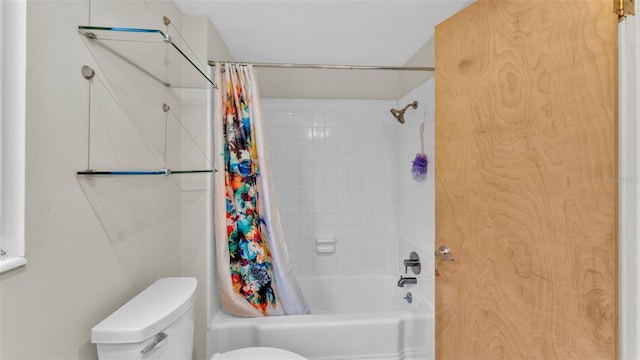 bathroom featuring shower / bath combination with curtain and toilet