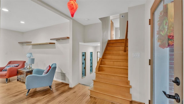 stairs featuring hardwood / wood-style floors