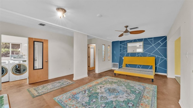 living area with ceiling fan, concrete flooring, and washer and clothes dryer