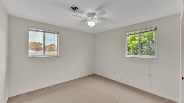 unfurnished room featuring light colored carpet and ceiling fan